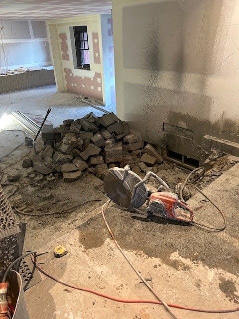 A circular saw is sitting on the floor in a room.