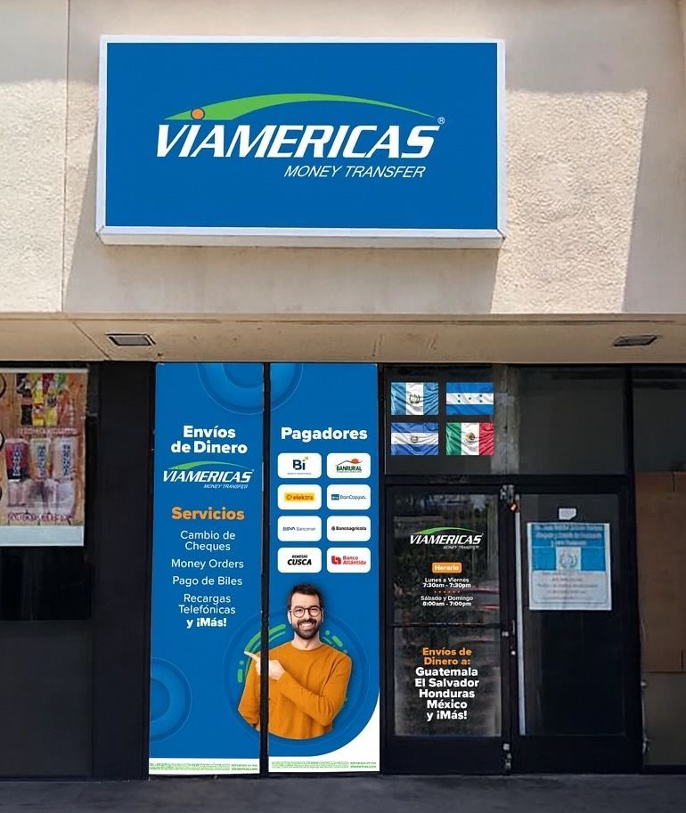Tan commercial building with a blue sign that reads 