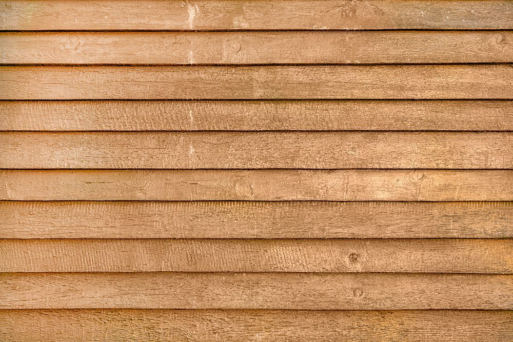 A close up of a wooden siding on a building.