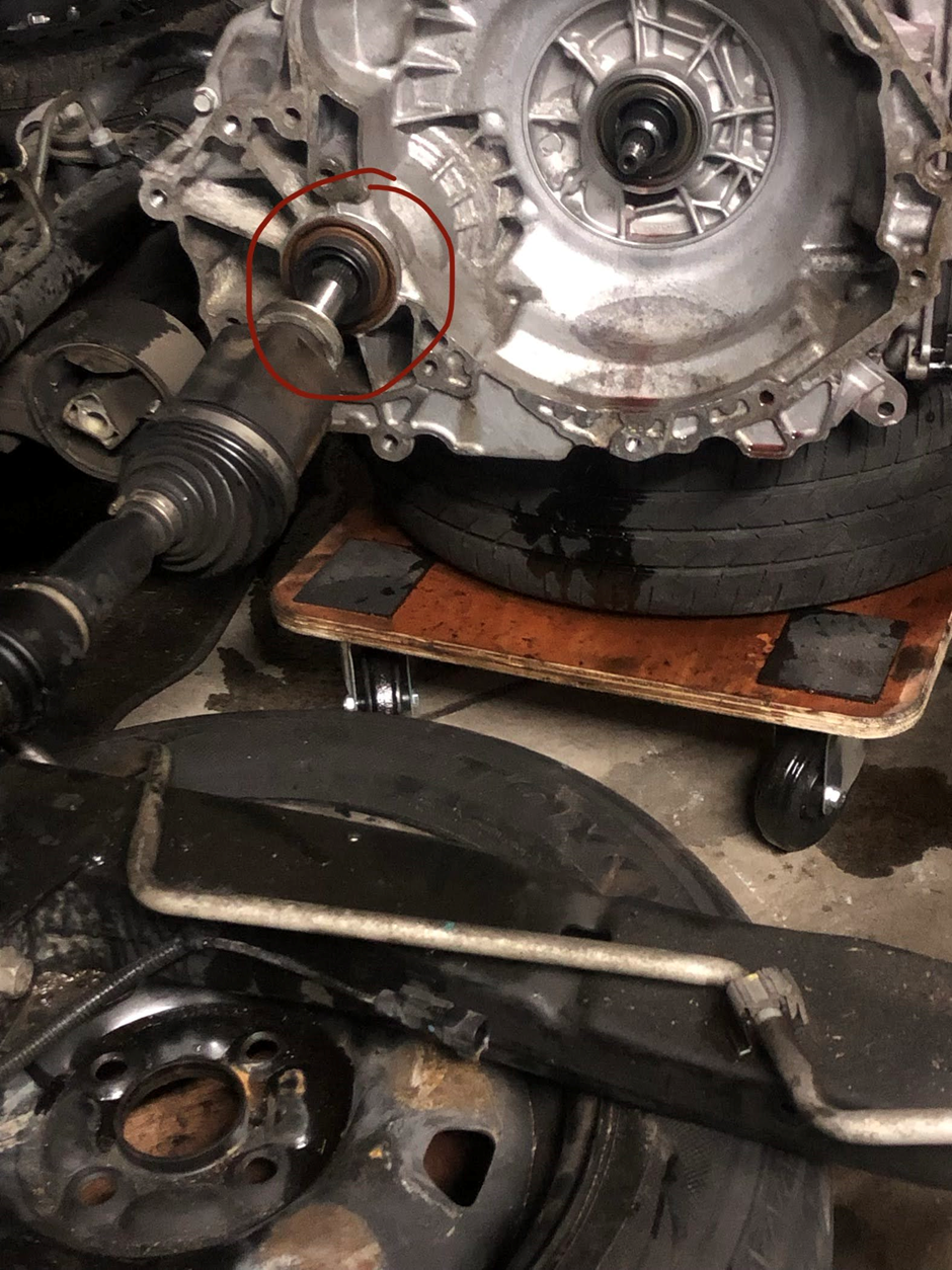 A close up of a car engine with a red circle around it