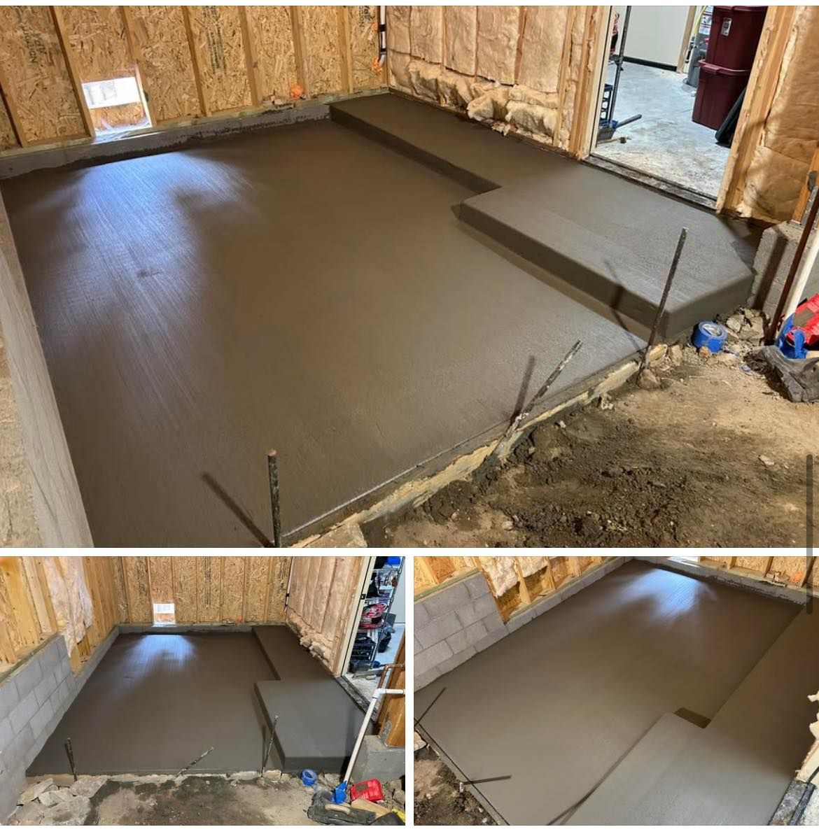 Freshly poured concrete floor inside a room, with a stepped area on one side, and wooden walls.