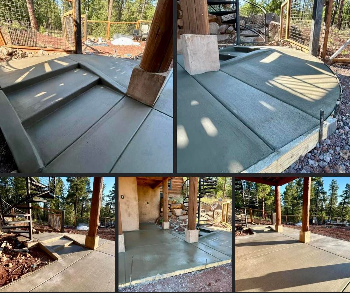 Concrete patio construction: stepped entry, curved edge, supported by wooden posts, surrounded by forest.
