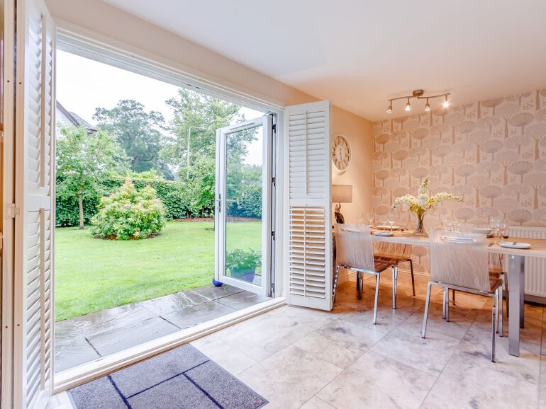 View from kitchen through French doors and into large garden