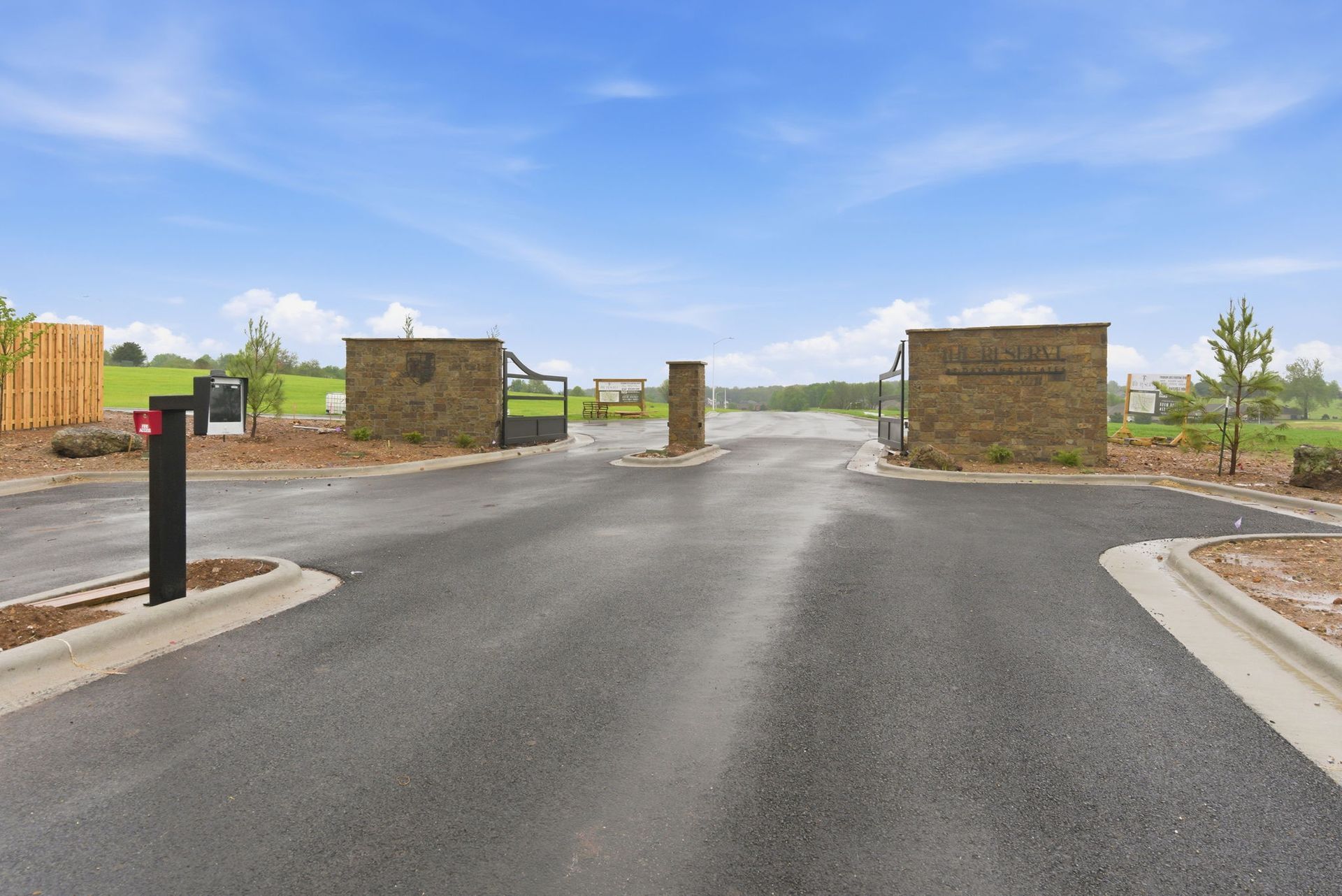Swimming pool with stone building, people swimming and lounging on a sunny day.
