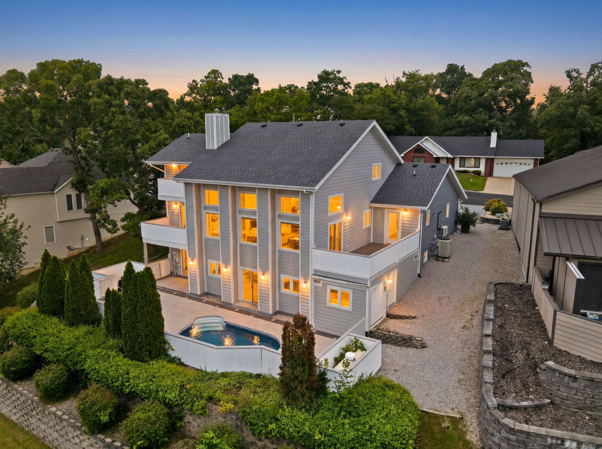Aerial view of a two-story home with a pool in Nixa, Missouri, during the late summer selling season