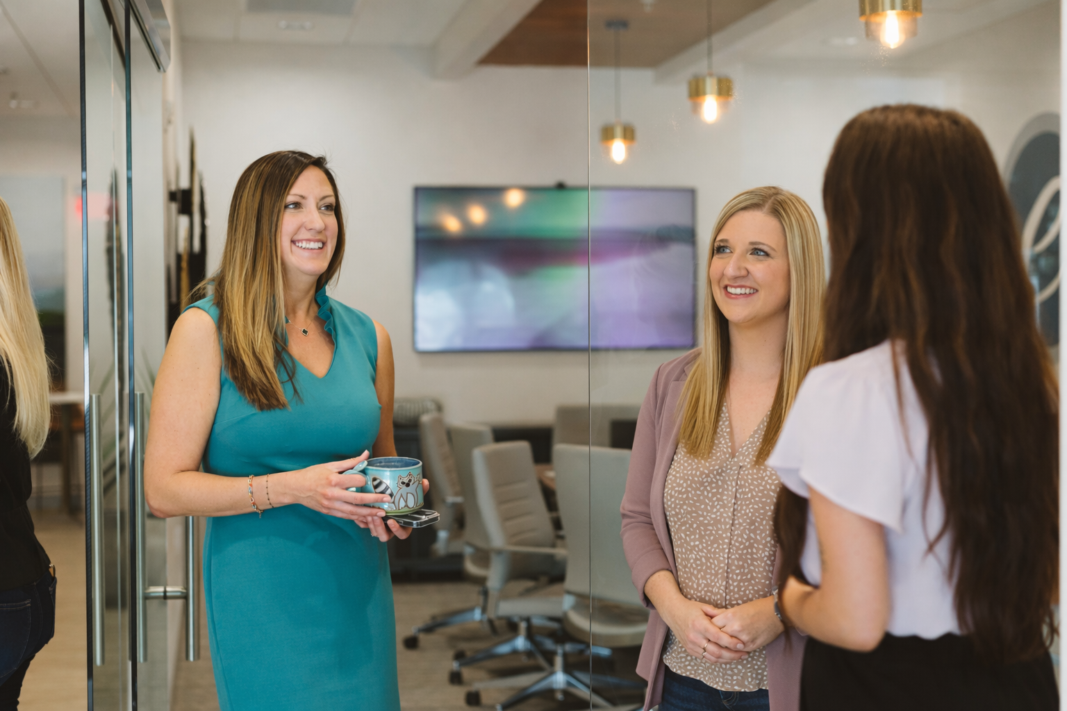 Aerial view of a suburban neighborhood with houses, streets, trees, and a golf course. Sunny day with clouds.