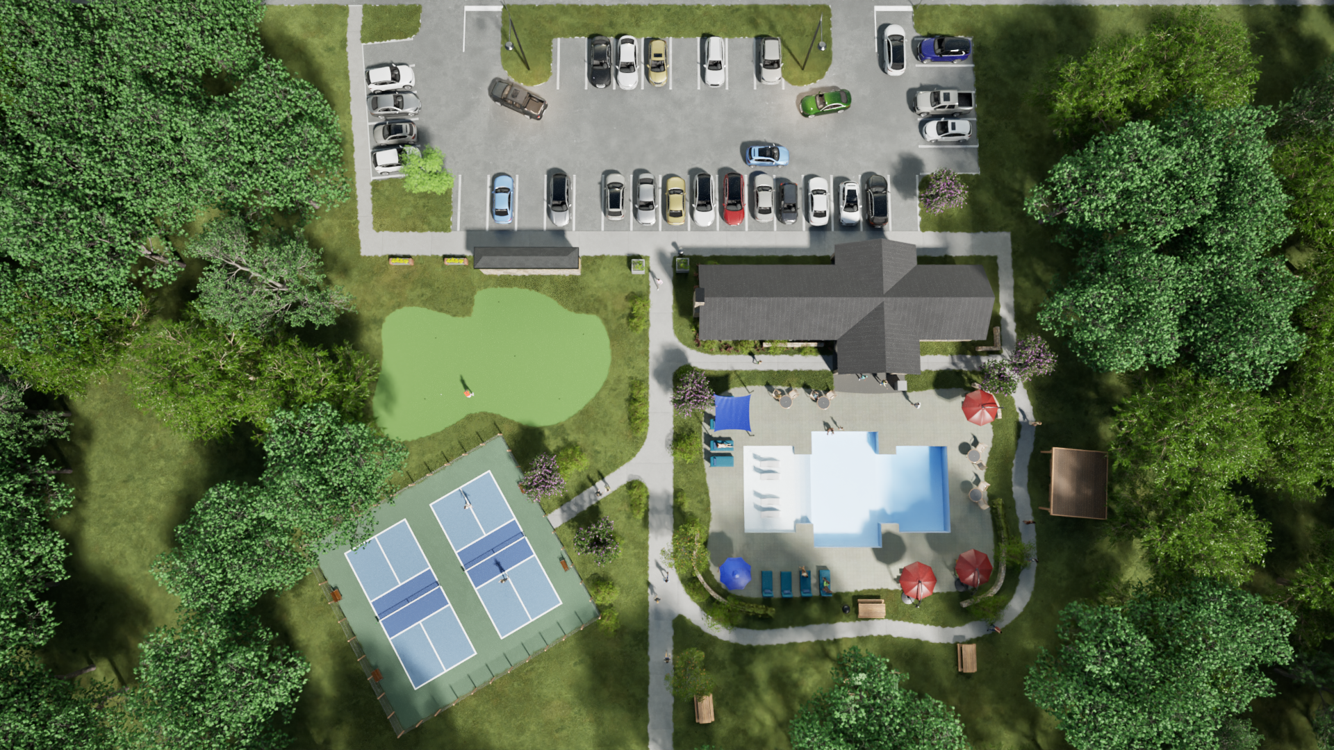 Aerial view of a community center with parking, pool, pickleball court, putting green, and surrounding trees.