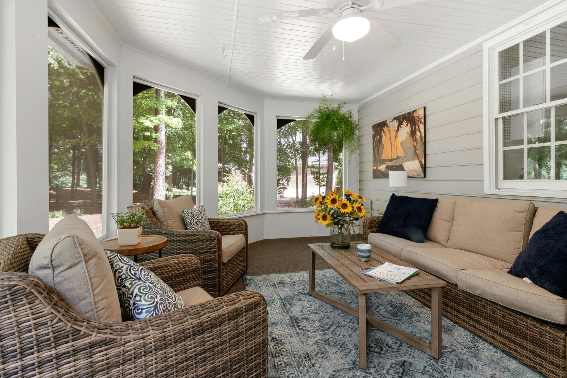 Aerial view of a suburban development with a lake, roads, and construction, bathed in golden sunlight.