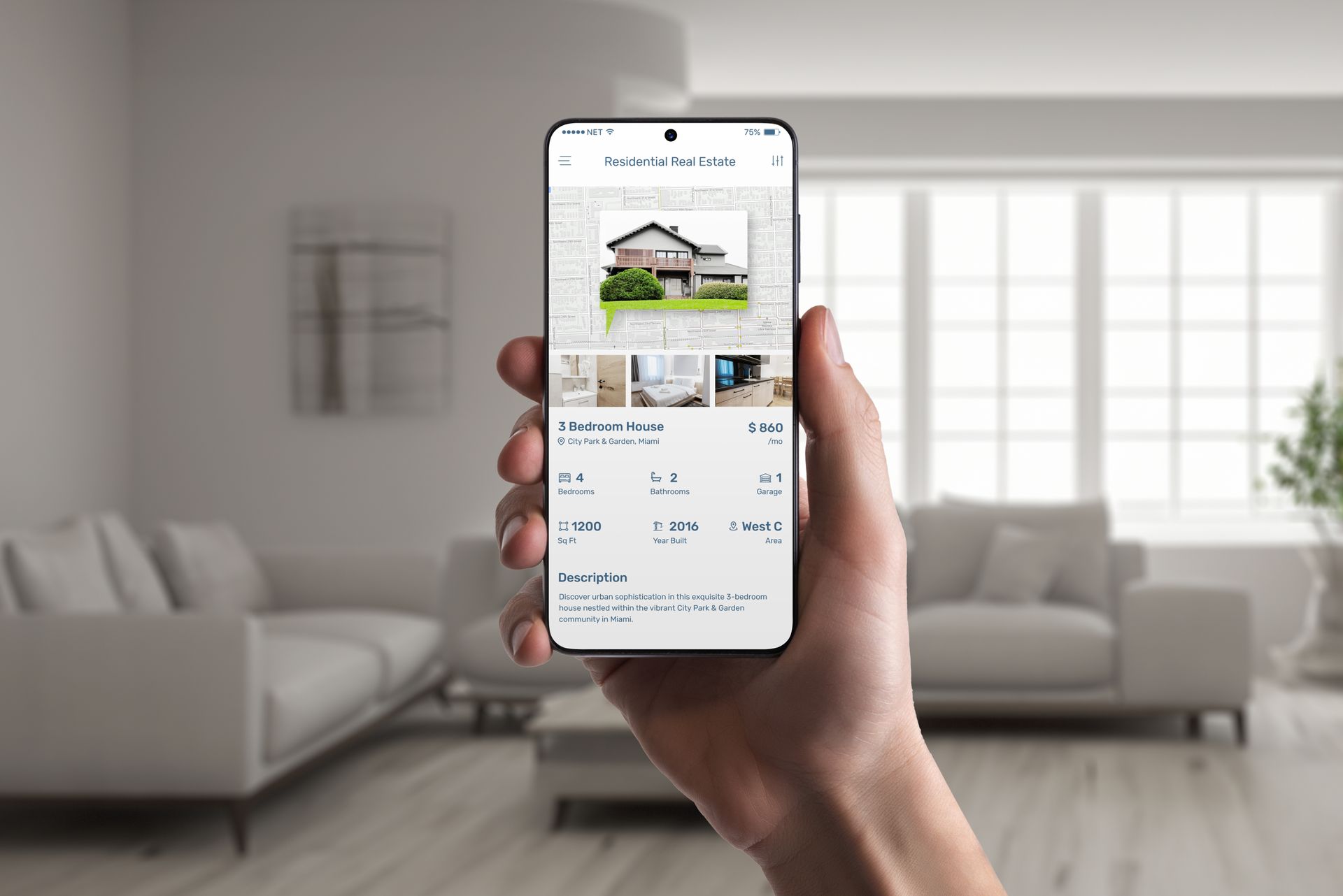 Hand holding phone displaying a real estate listing in a bright living room.