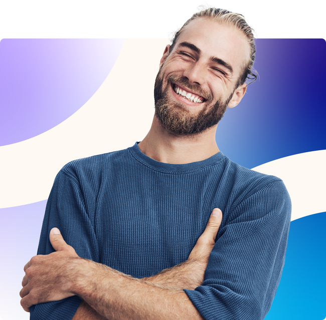 Smiling man with folded arms in a blue sweater against a white, purple, and blue abstract background