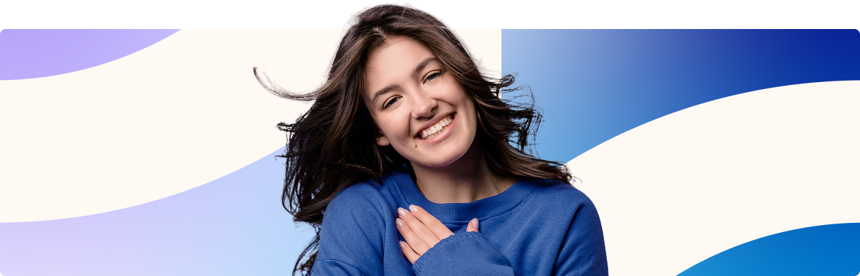Smiling person in a blue sweater against a white and blue abstract background