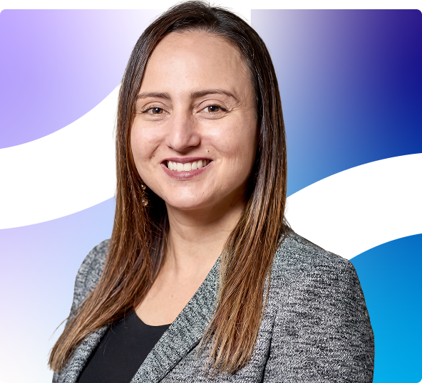 Portrait of a smiling woman in a gray blazer against a purple and blue abstract background