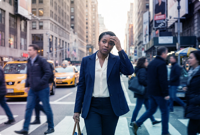 Two men in a bright office talking at a table with an open notebook and folders nearby