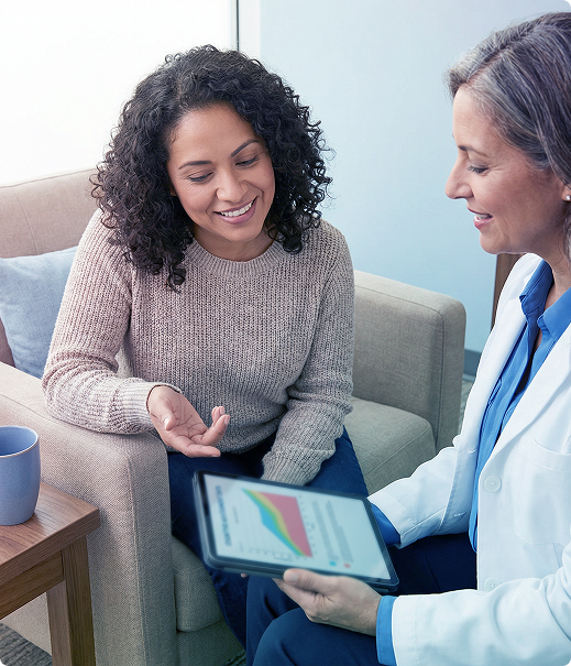 Woman discusses chart on tablet with a clinician in a counseling office
