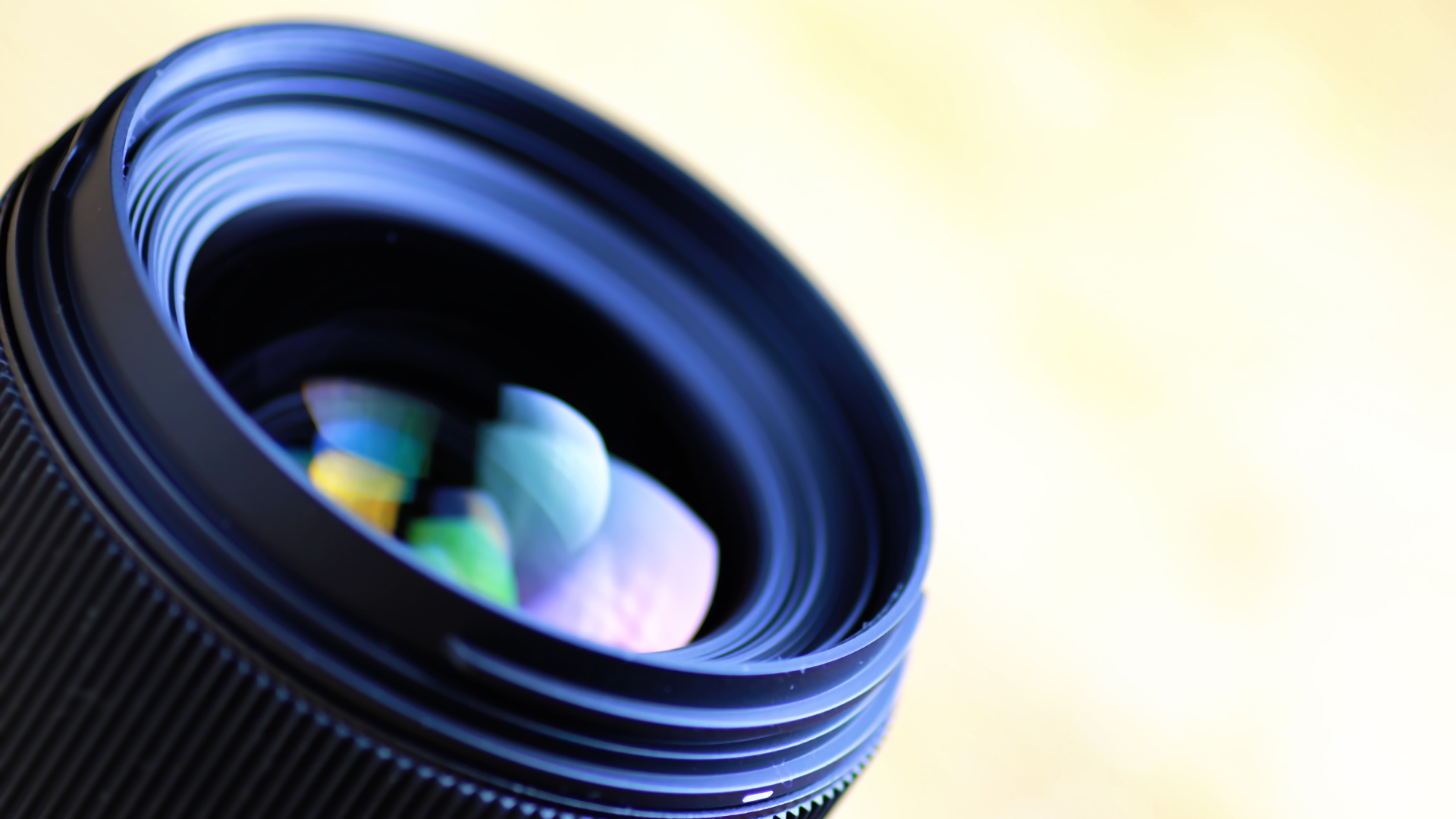 A scientist is looking through a microscope at a plant in a test tube.