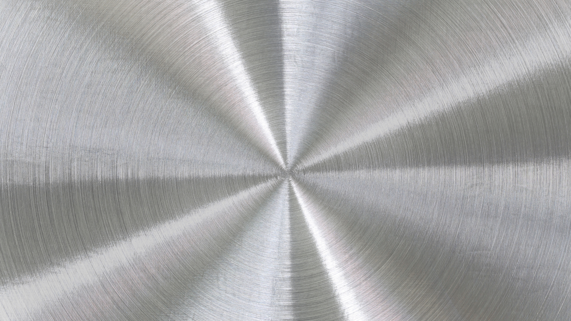 A close up of a stainless steel surface with a circular pattern.