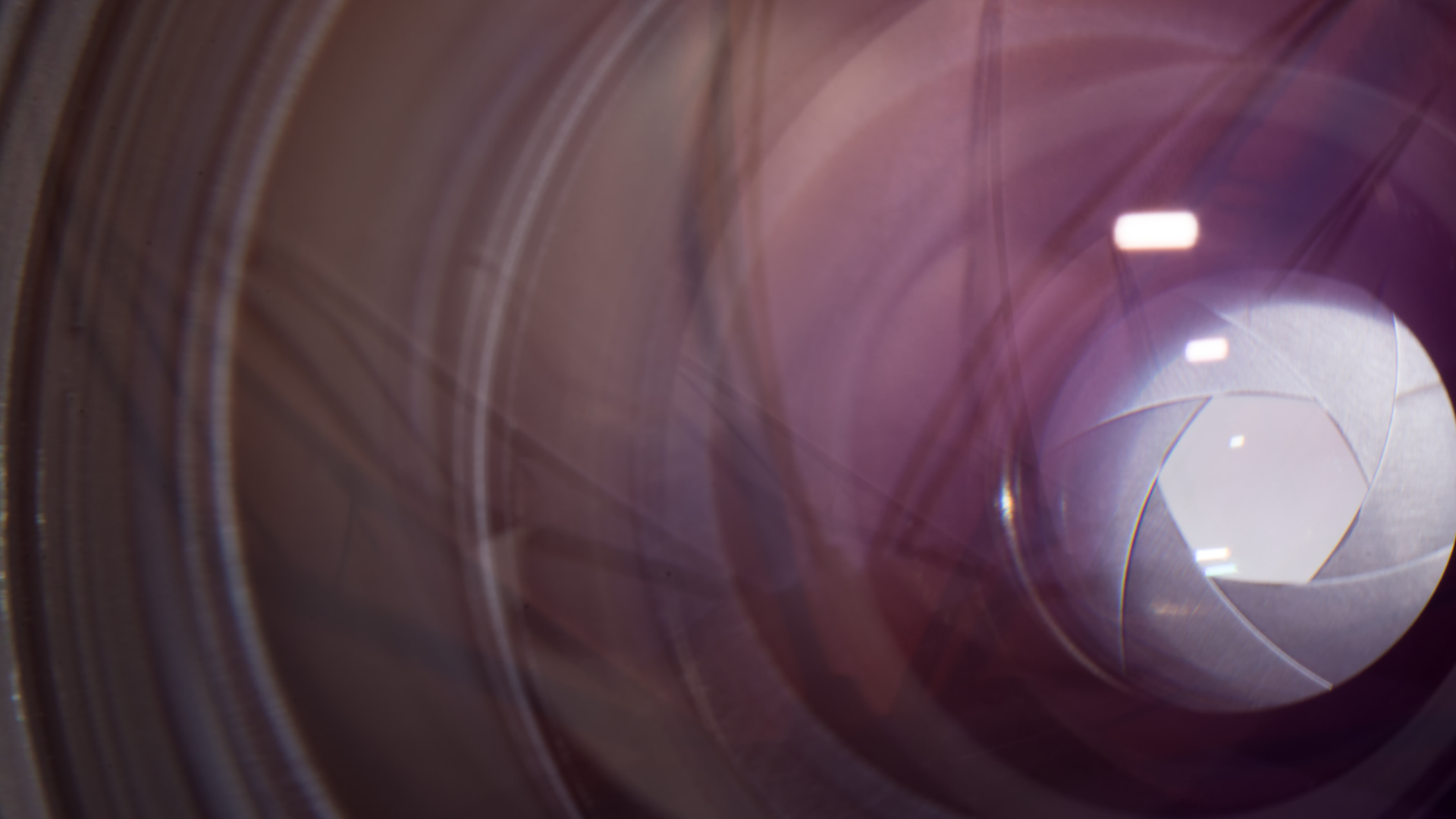 A close up of a camera lens with the shutter open.