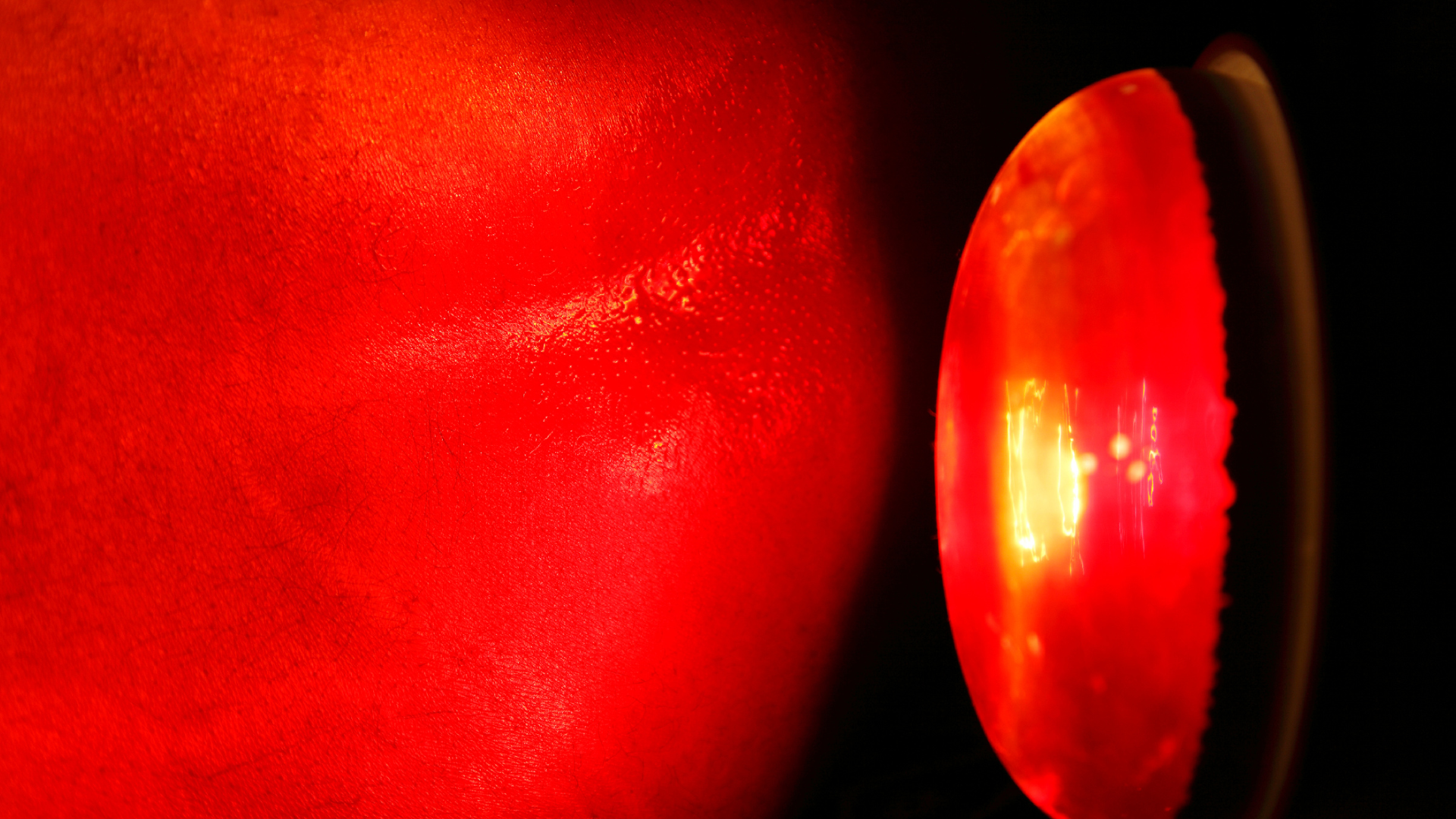 A close up of a red object with a light coming out of it.
