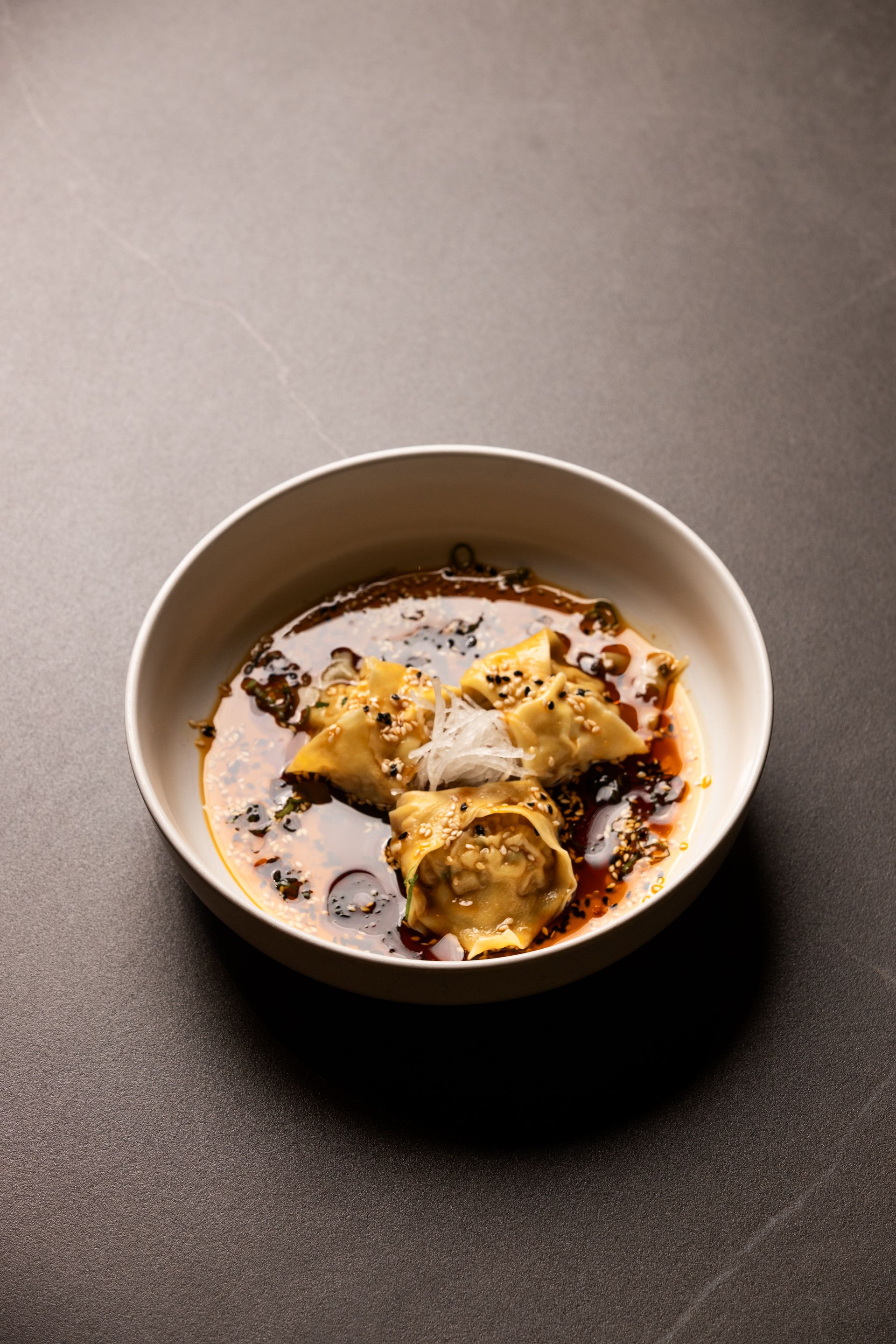 A close up of a bowl of food on a table.