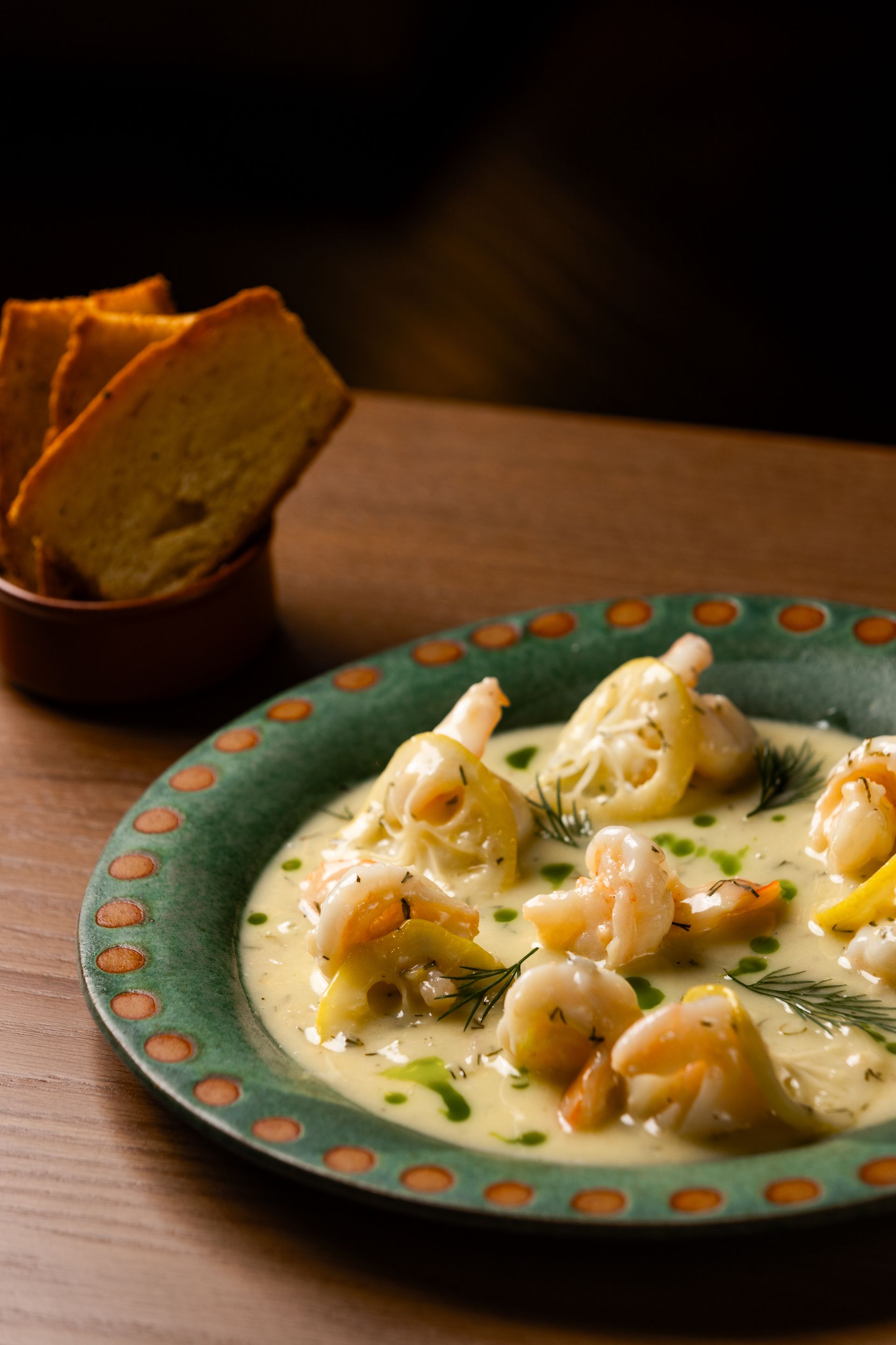 A plate of food with shrimp and bread on a table.