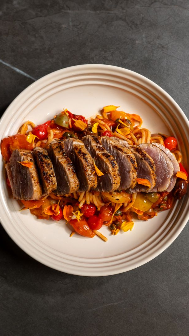 Gin and tonic cocktail with mixed fresh fruits