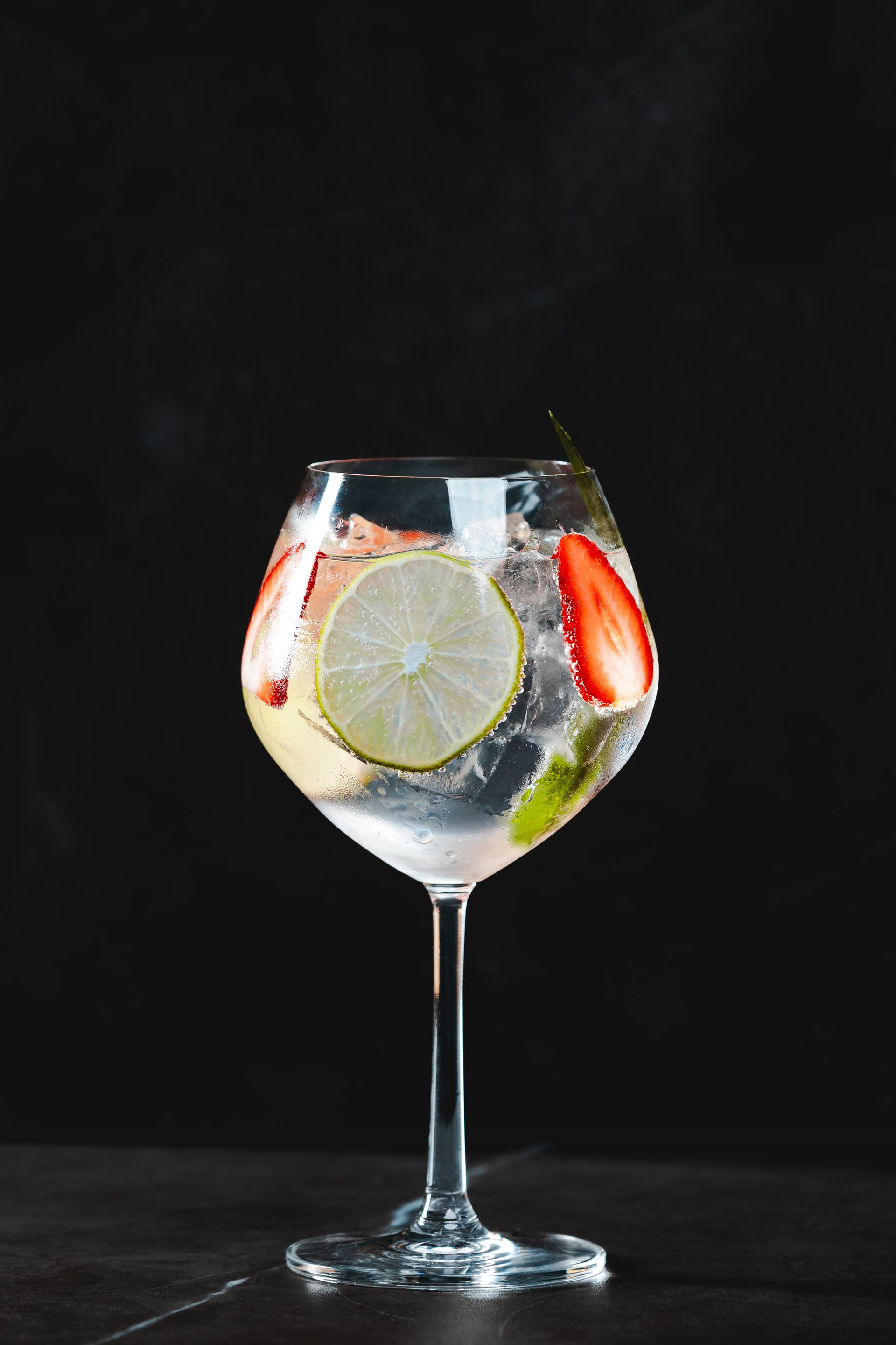 Gin and tonic cocktail with mixed fresh fruits