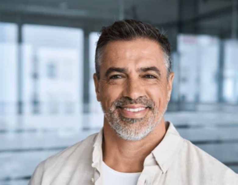 A man with a beard and mustache is smiling for the camera.