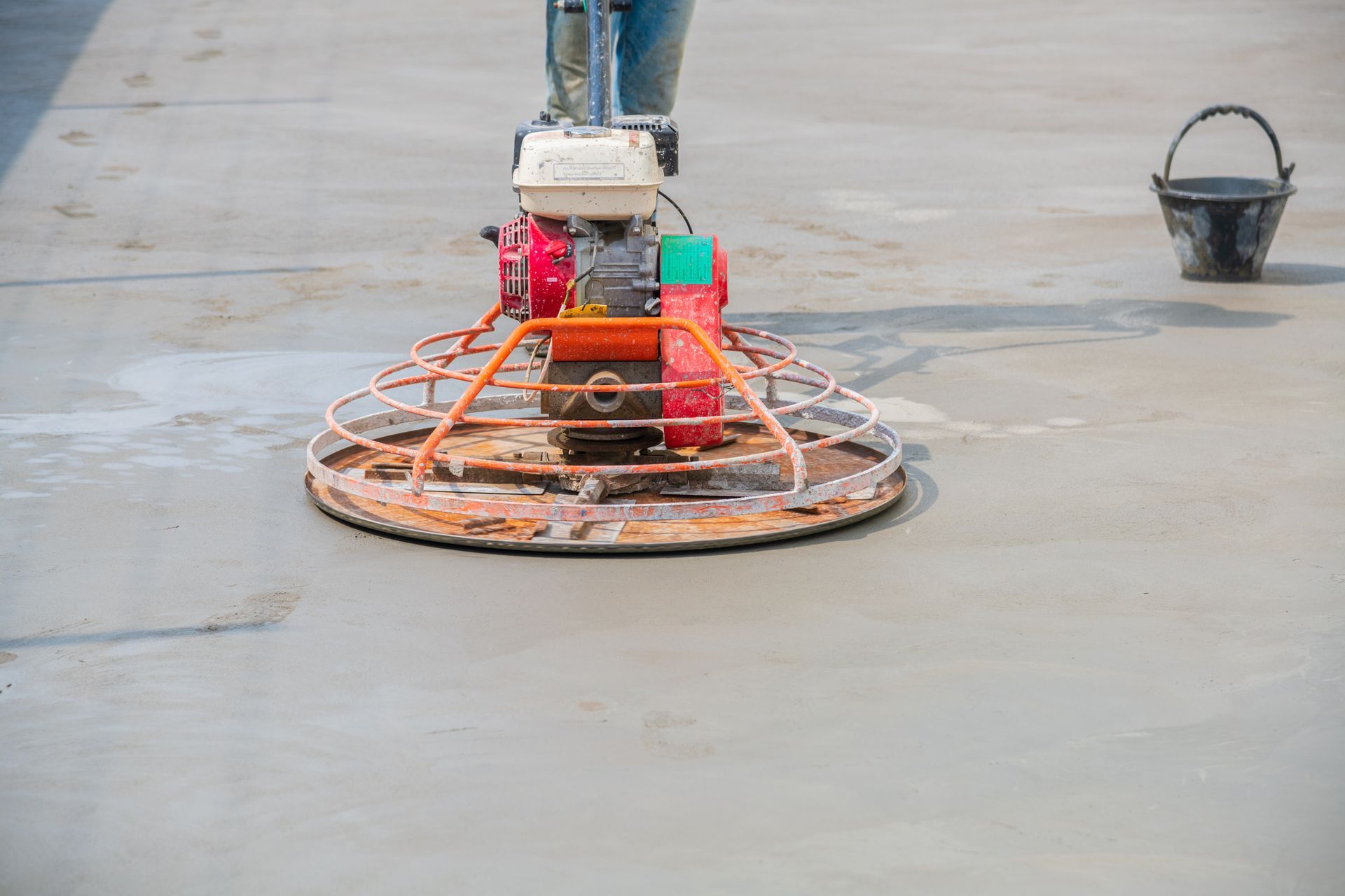 A person is using a machine to finish a concrete floor.