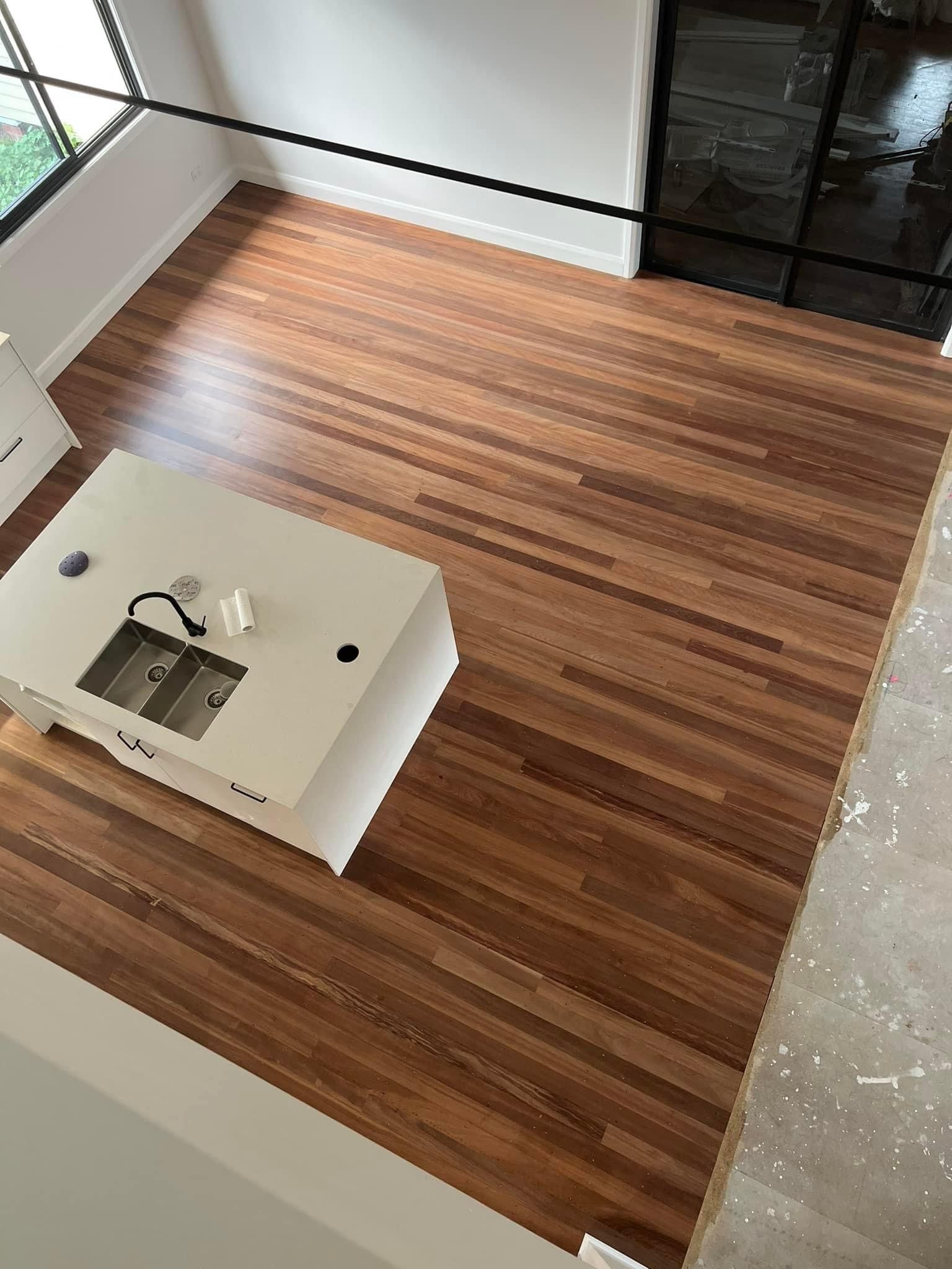 An aerial view of a kitchen with a wooden floor and a sink.