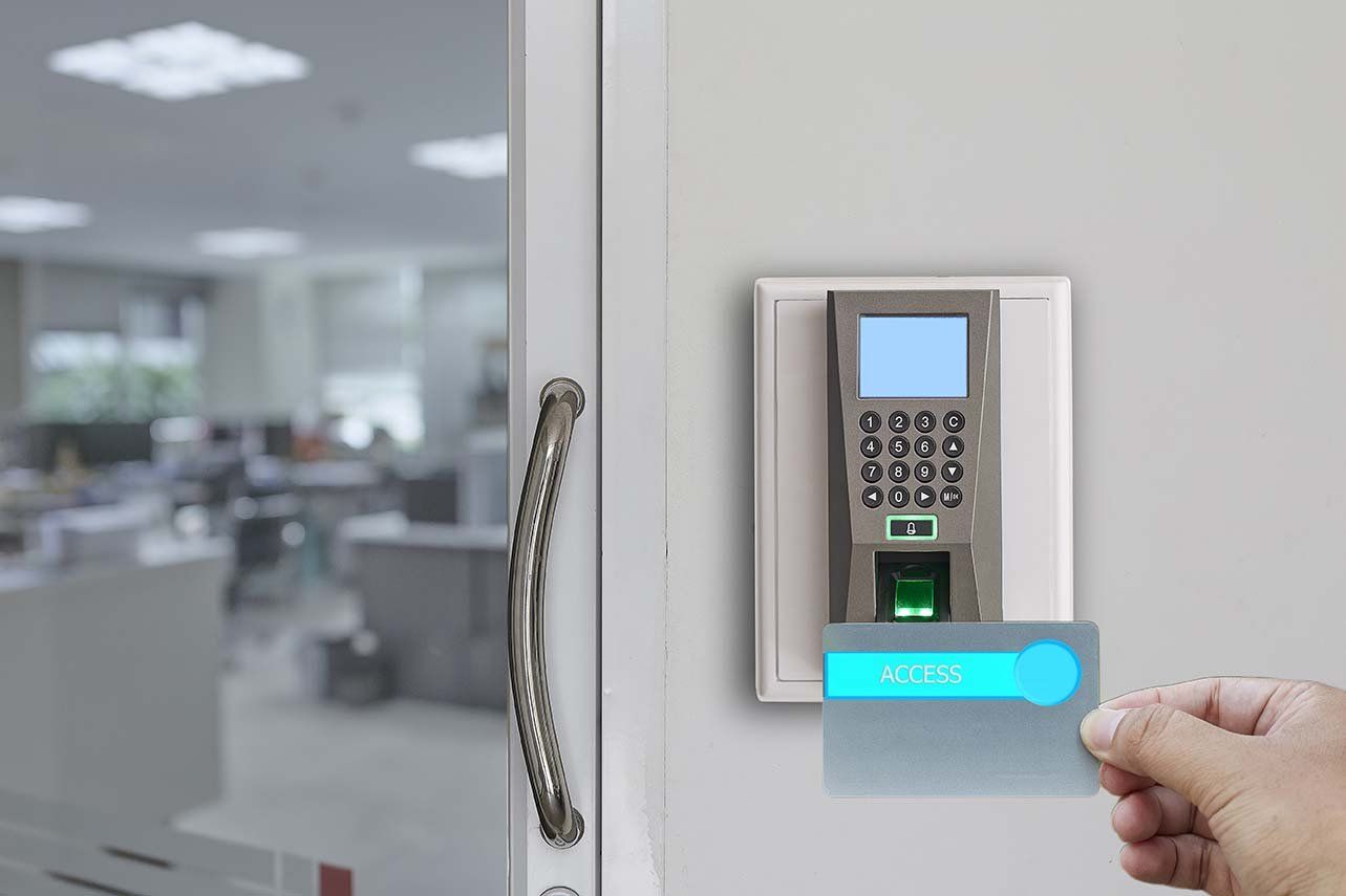 A person is using a fingerprint scanner to open a door.