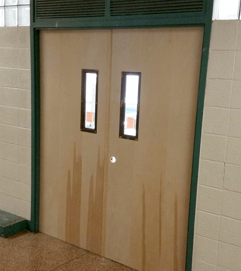 A brown door with two windows on it
