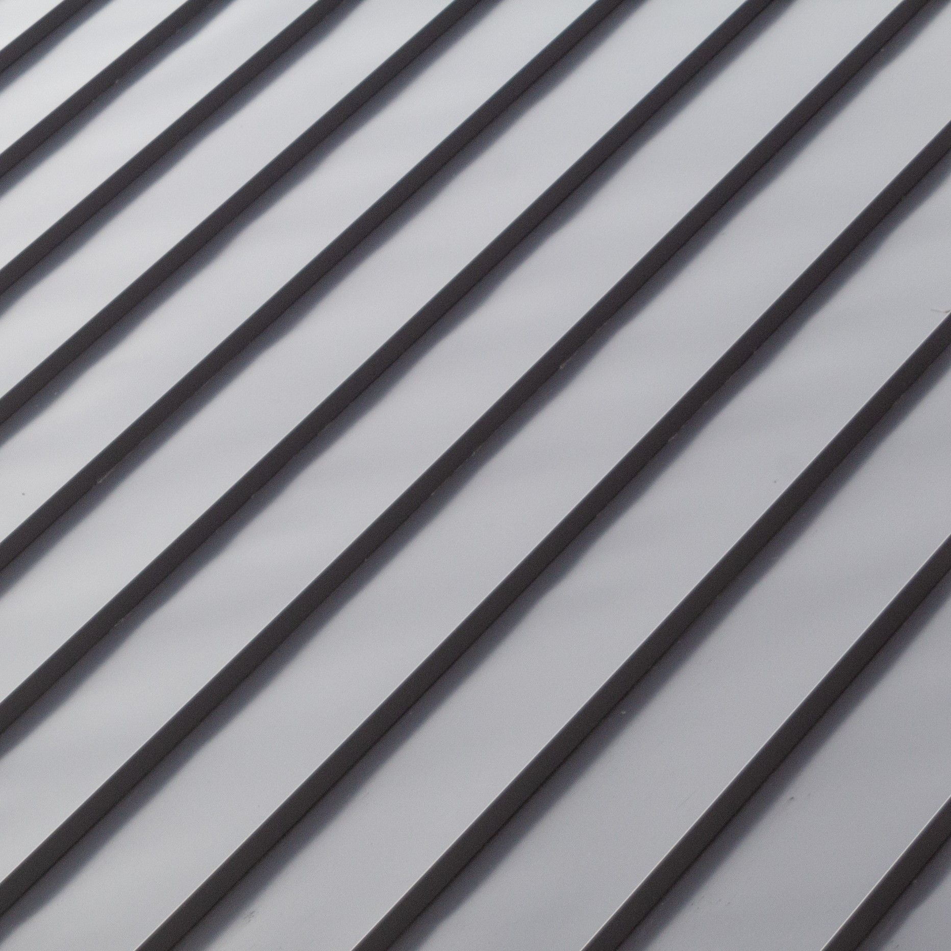 A close up of a gray roof with a diagonal pattern.