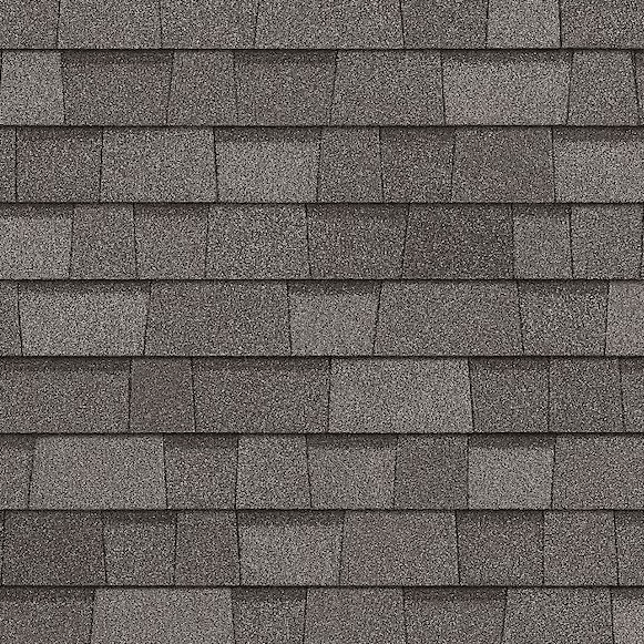 A close up of a row of gray shingles on a roof.