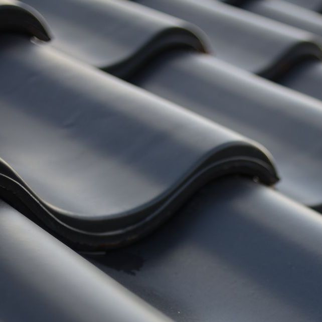 A close up of a black tile roof