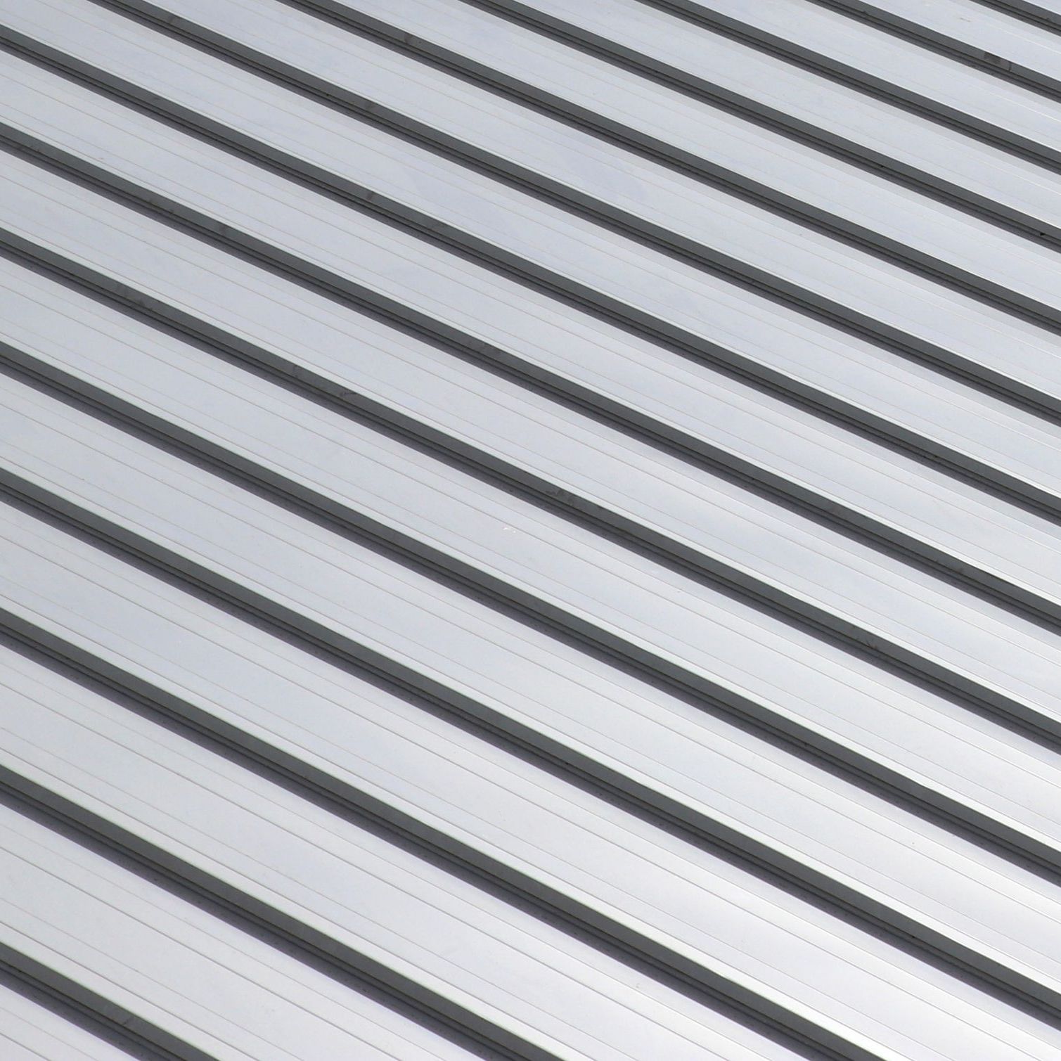 A close up of a metal roof with a diagonal pattern.
