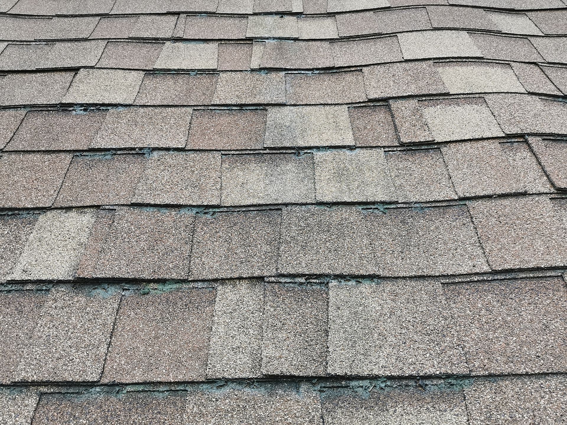 A close up of a roof with a lot of shingles on it.