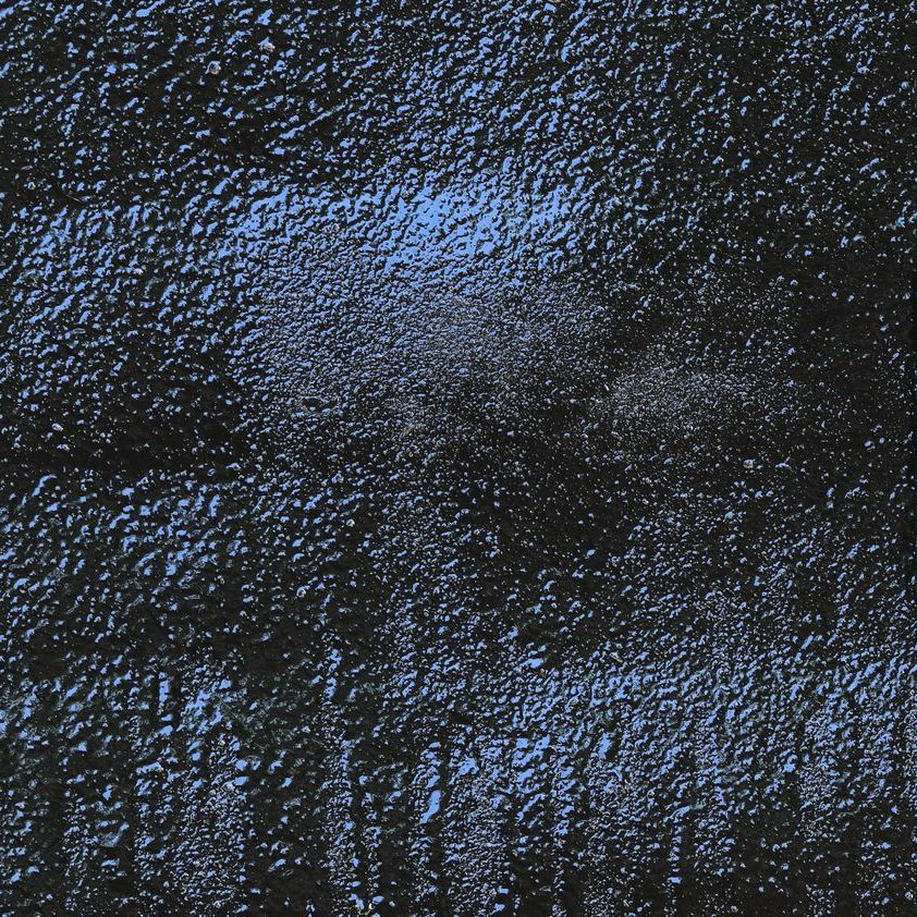 A close up of a black surface with moisture on it