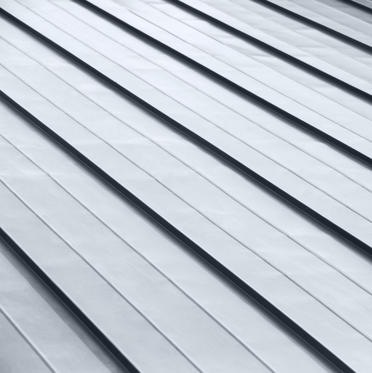 A close up of a metal roof with a diagonal pattern