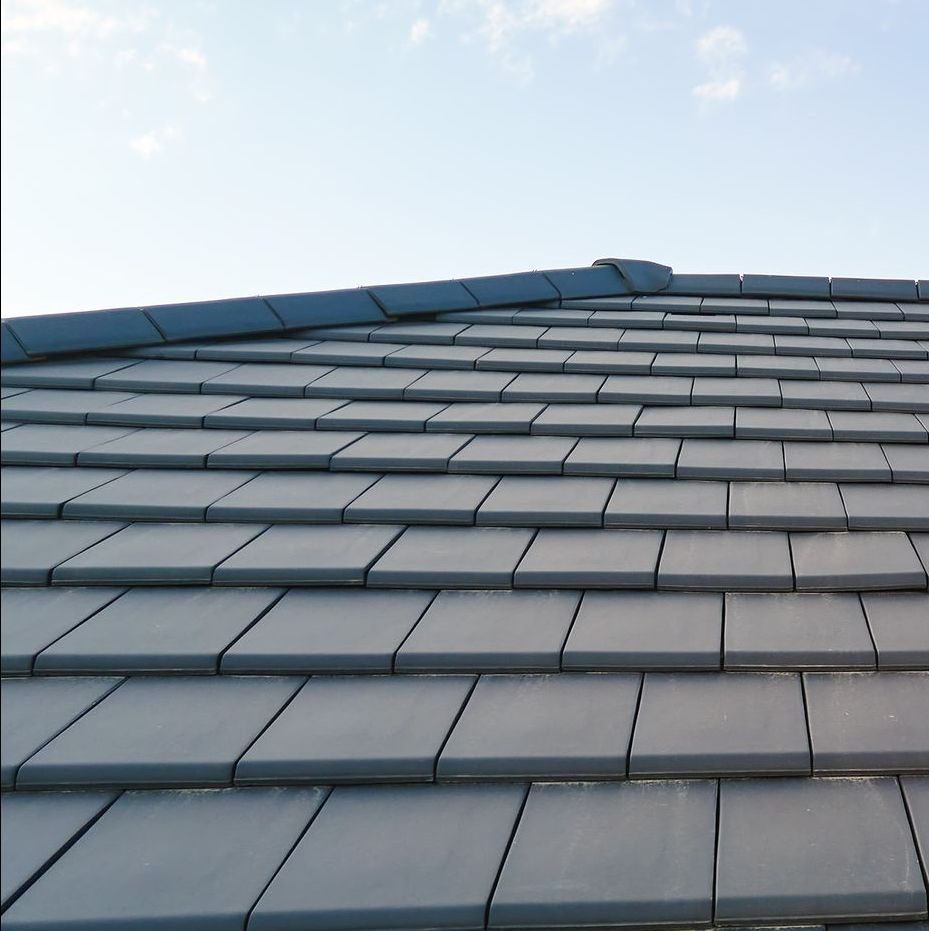 A slate roof with a blue sky in the background