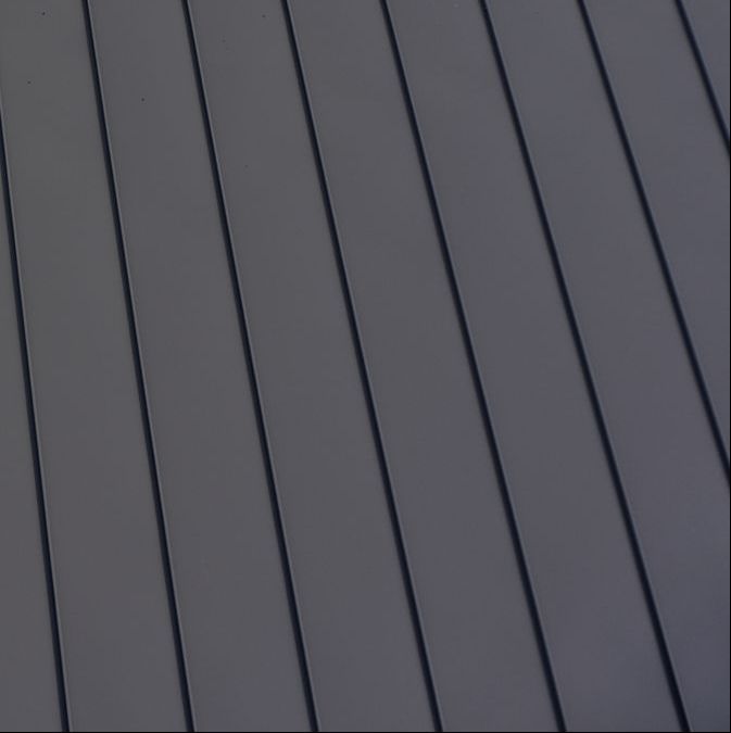 A close up of a gray metal roof with a diagonal pattern.