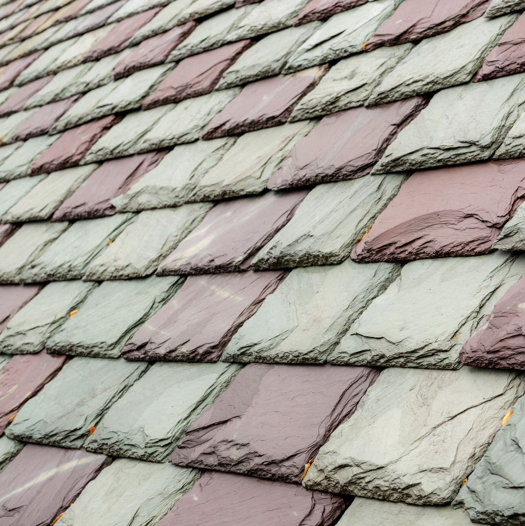 A close up of a roof with purple and grey tiles