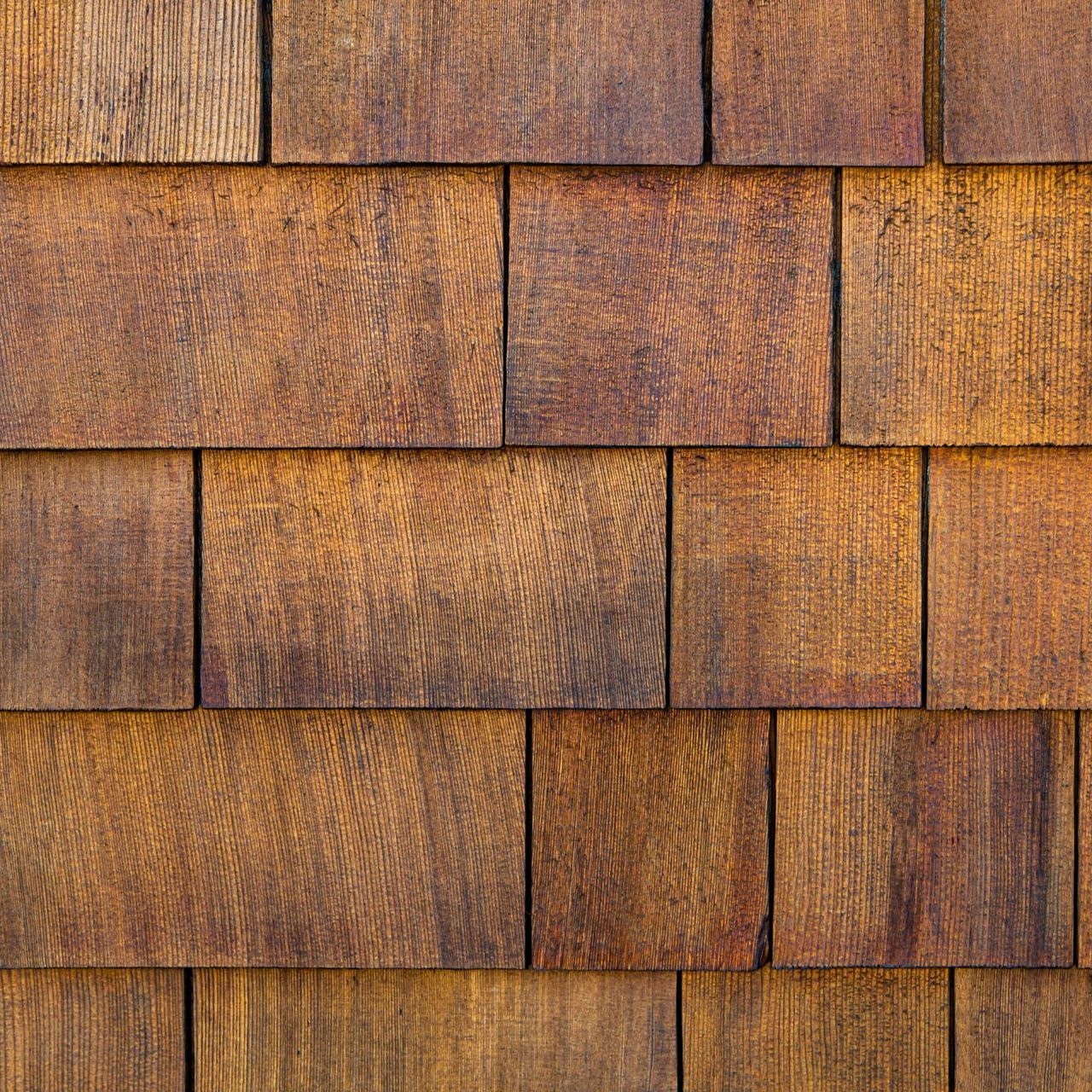A close up of a wooden shingle roof.