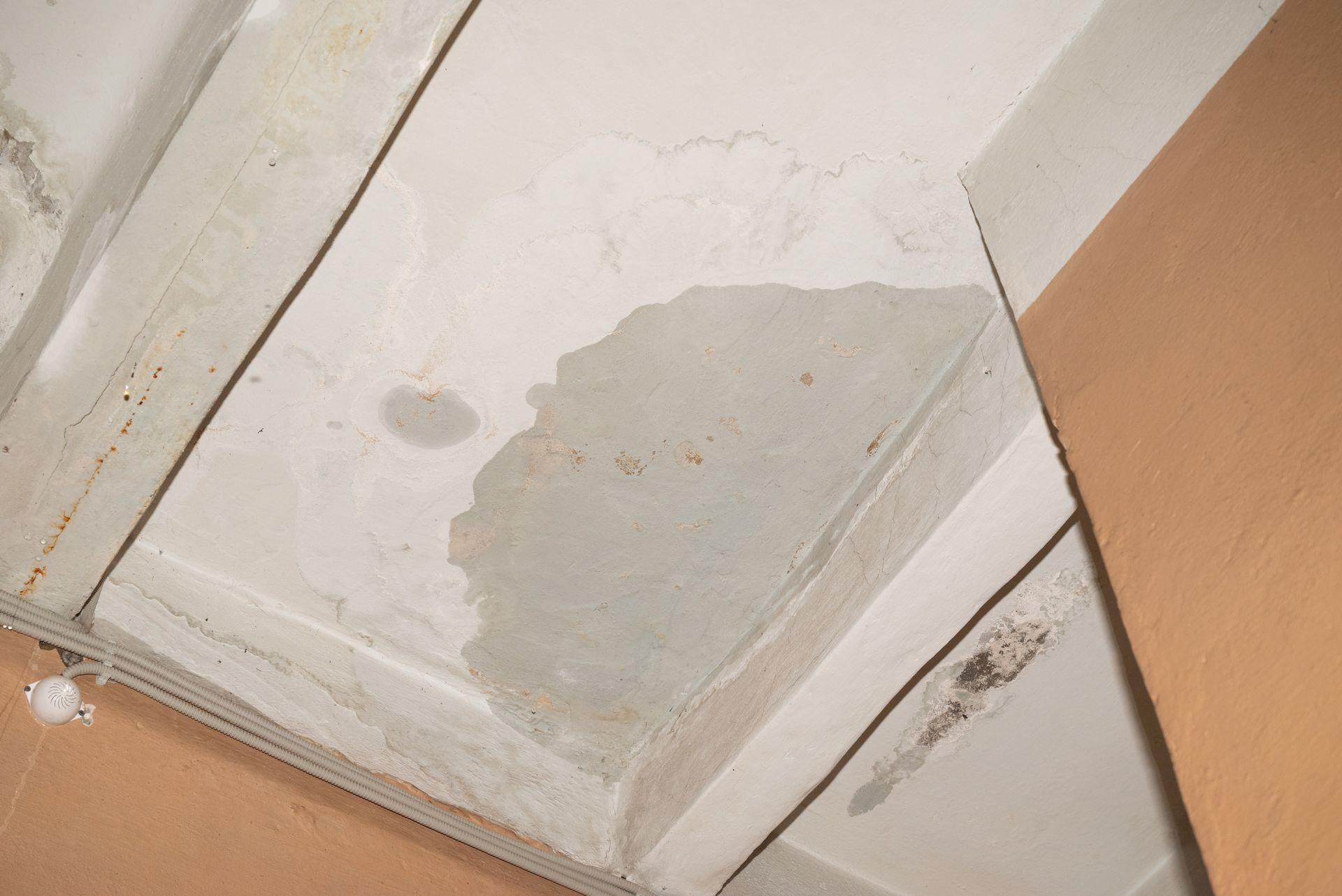 A close up of a ceiling with a stain on it.