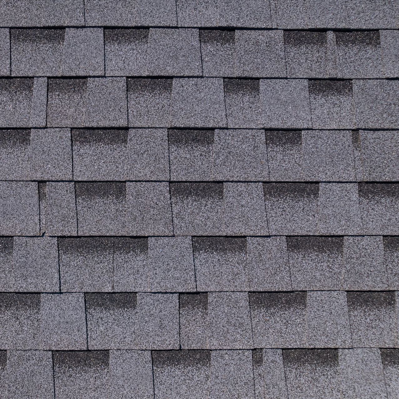 A close up of a roof with a lot of shingles on it.