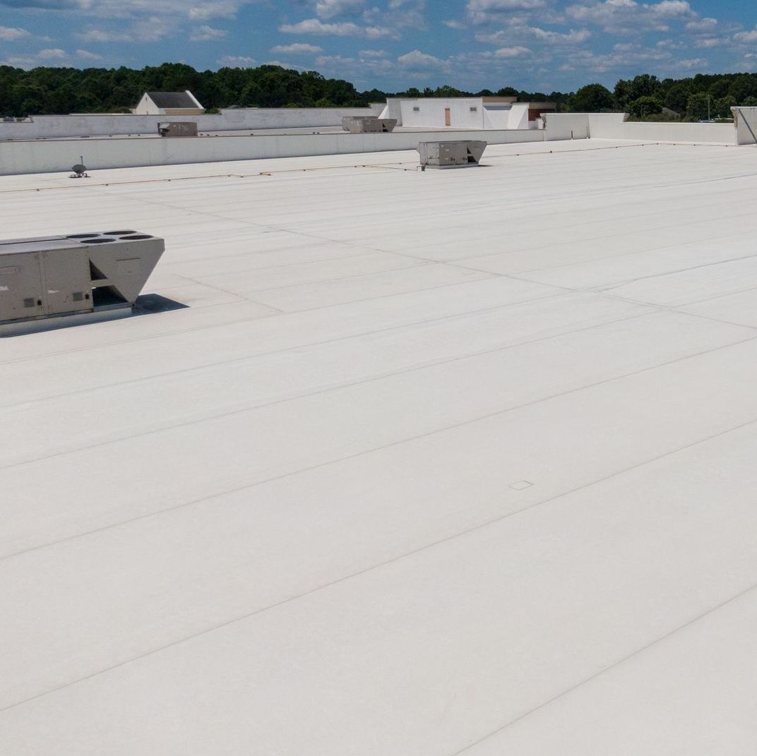 A large white roof with a lot of vents on it.