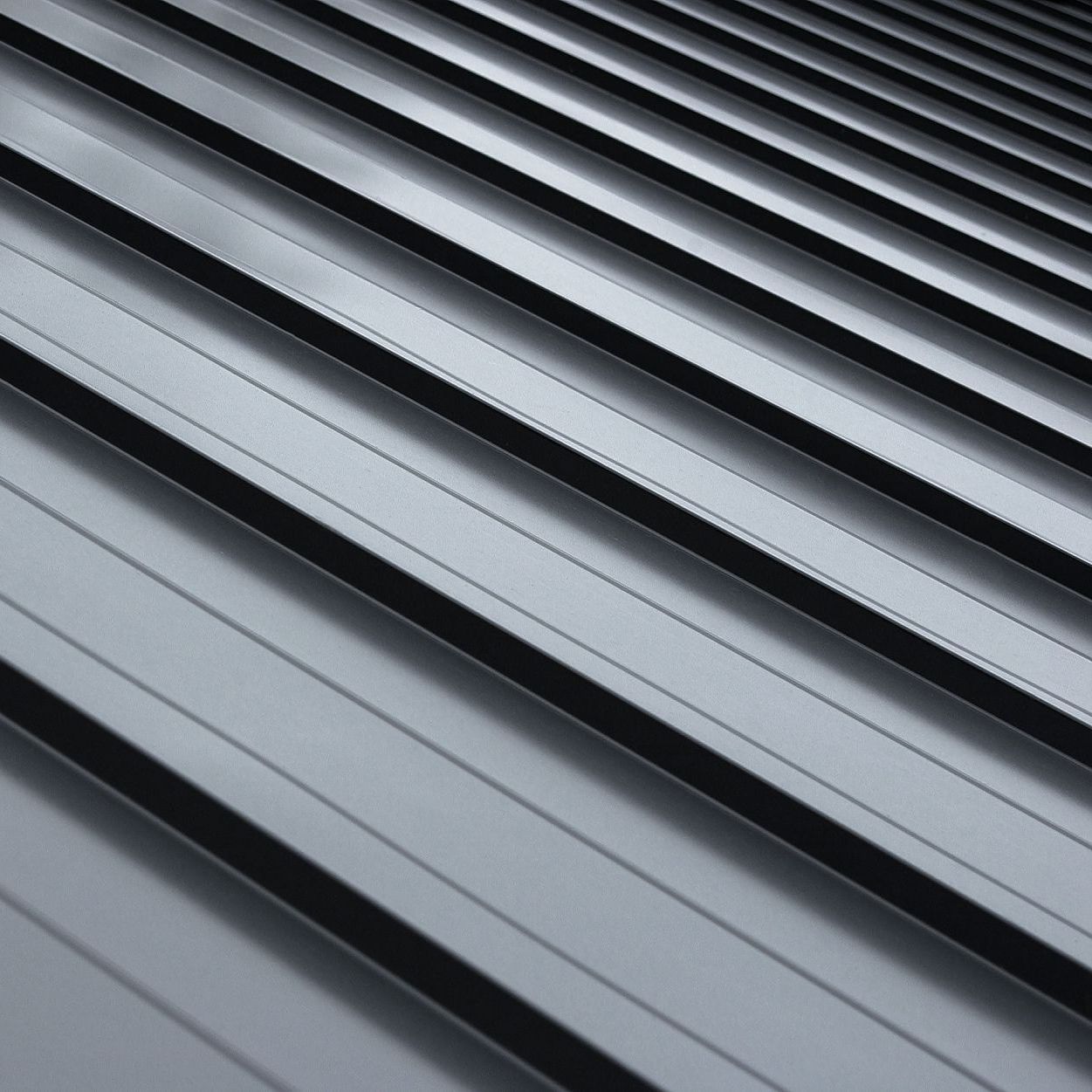 A close up of a gray metal roof with a diagonal pattern