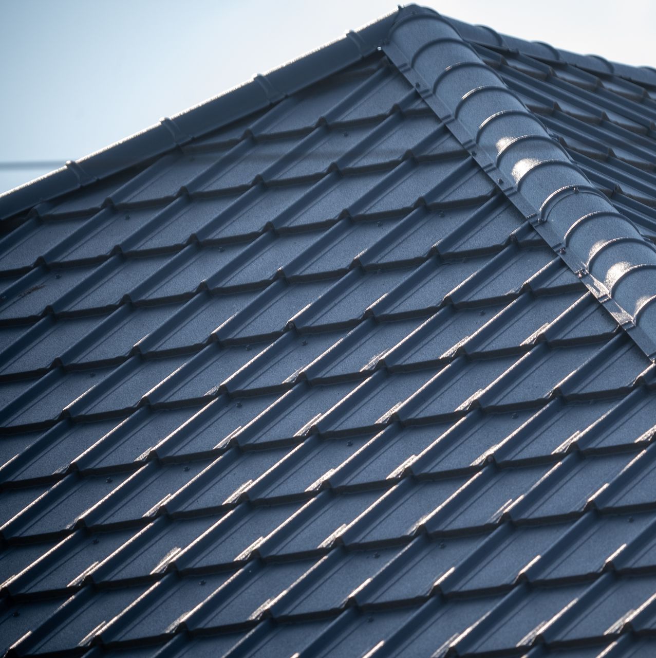 A close up of a blue tiled roof
