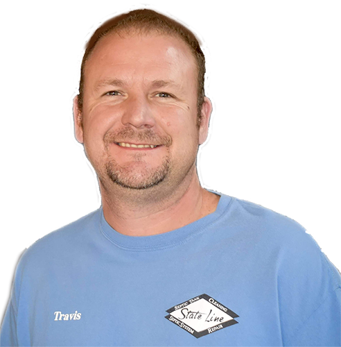 A man wearing a blue shirt with the name travis on it