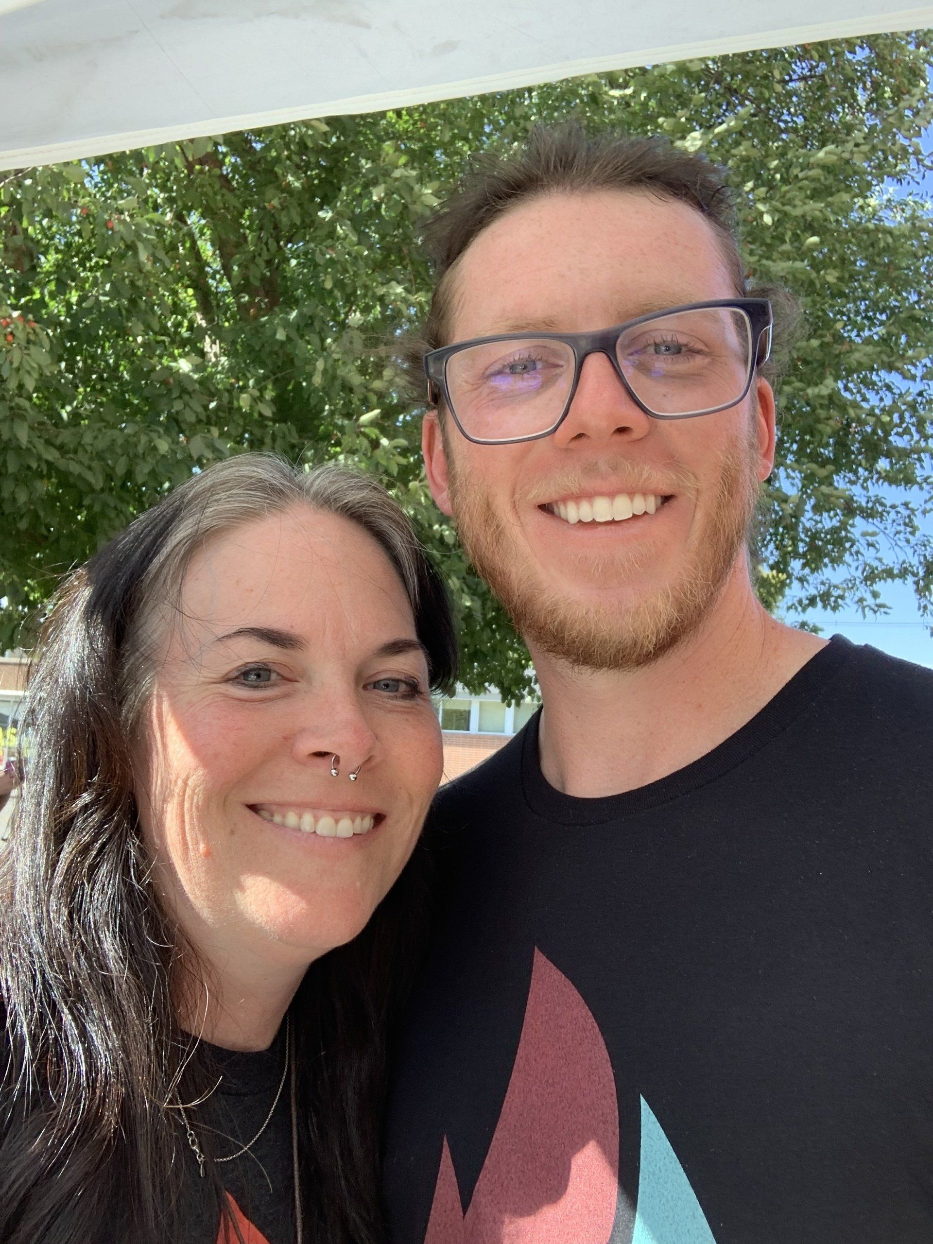 Virgie and Clay are posing for a picture together and smiling.