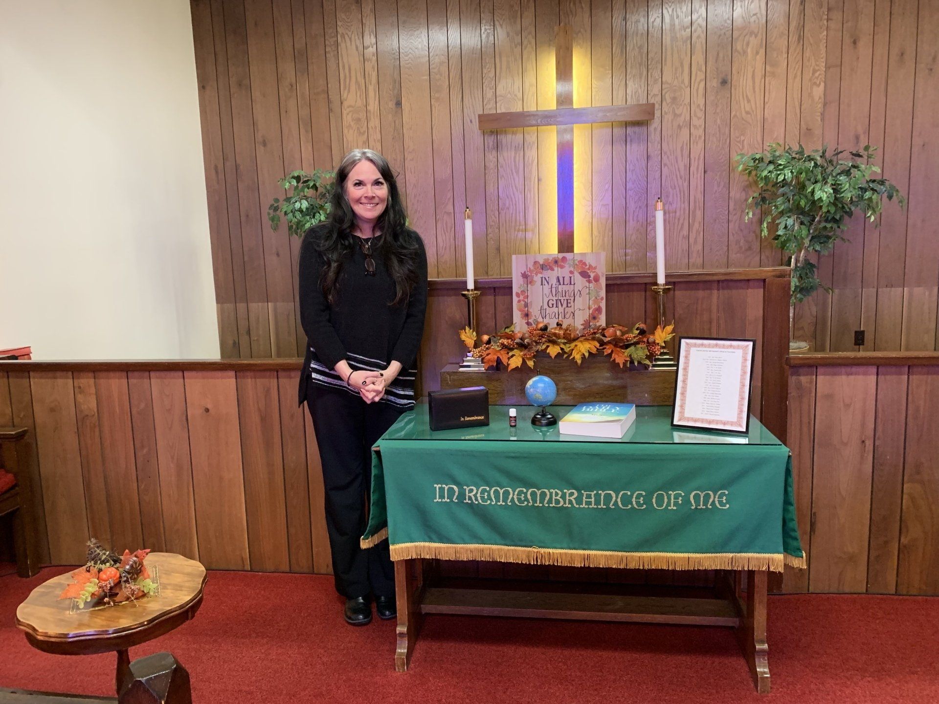 Pastor Virgie is standing in front of an altar in a church.